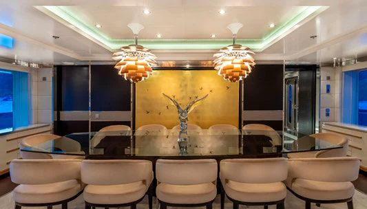 a large room with a chandelier and chairs aboard SCOTT FREE Yacht for Charter