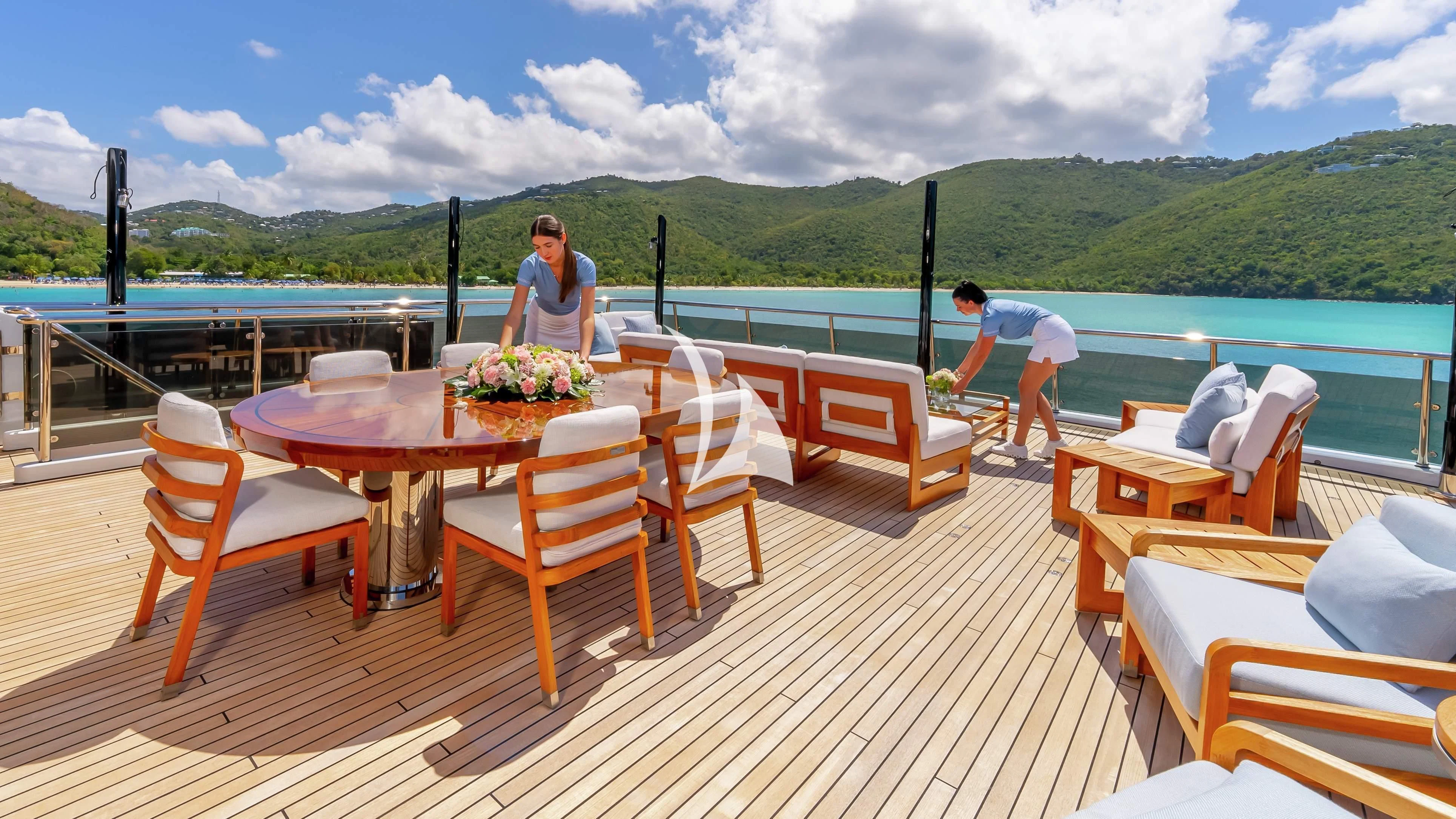 a couple of women standing on a deck overlooking a body of water aboard SCOTT FREE Yacht for Charter