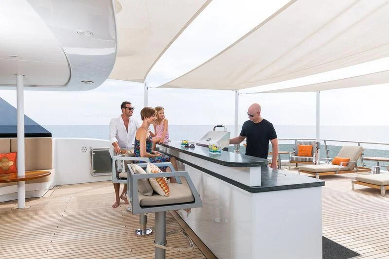 people standing around a table aboard SCOTT FREE Yacht for Charter