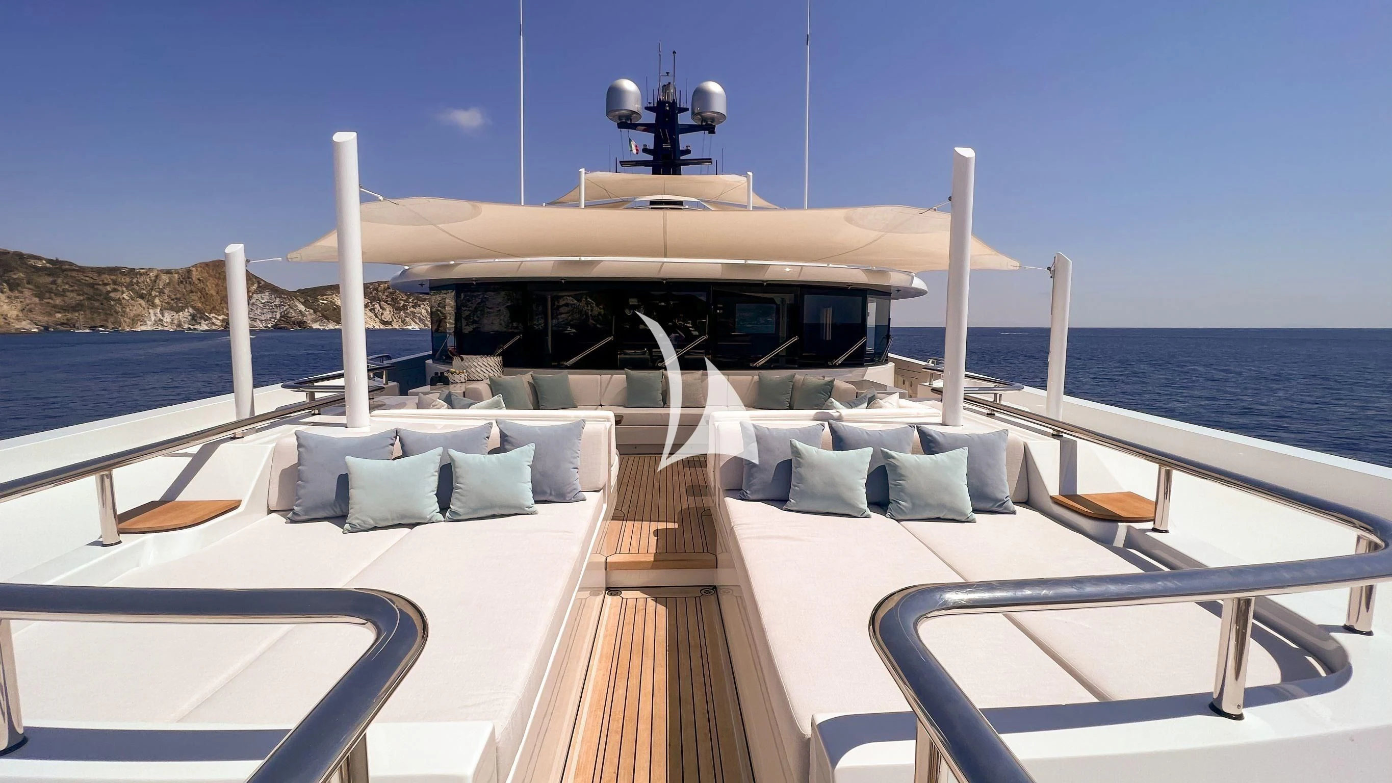 a lounge area with lounge chairs and a large white gazebo on a sunny day aboard SCOTT FREE Yacht for Charter