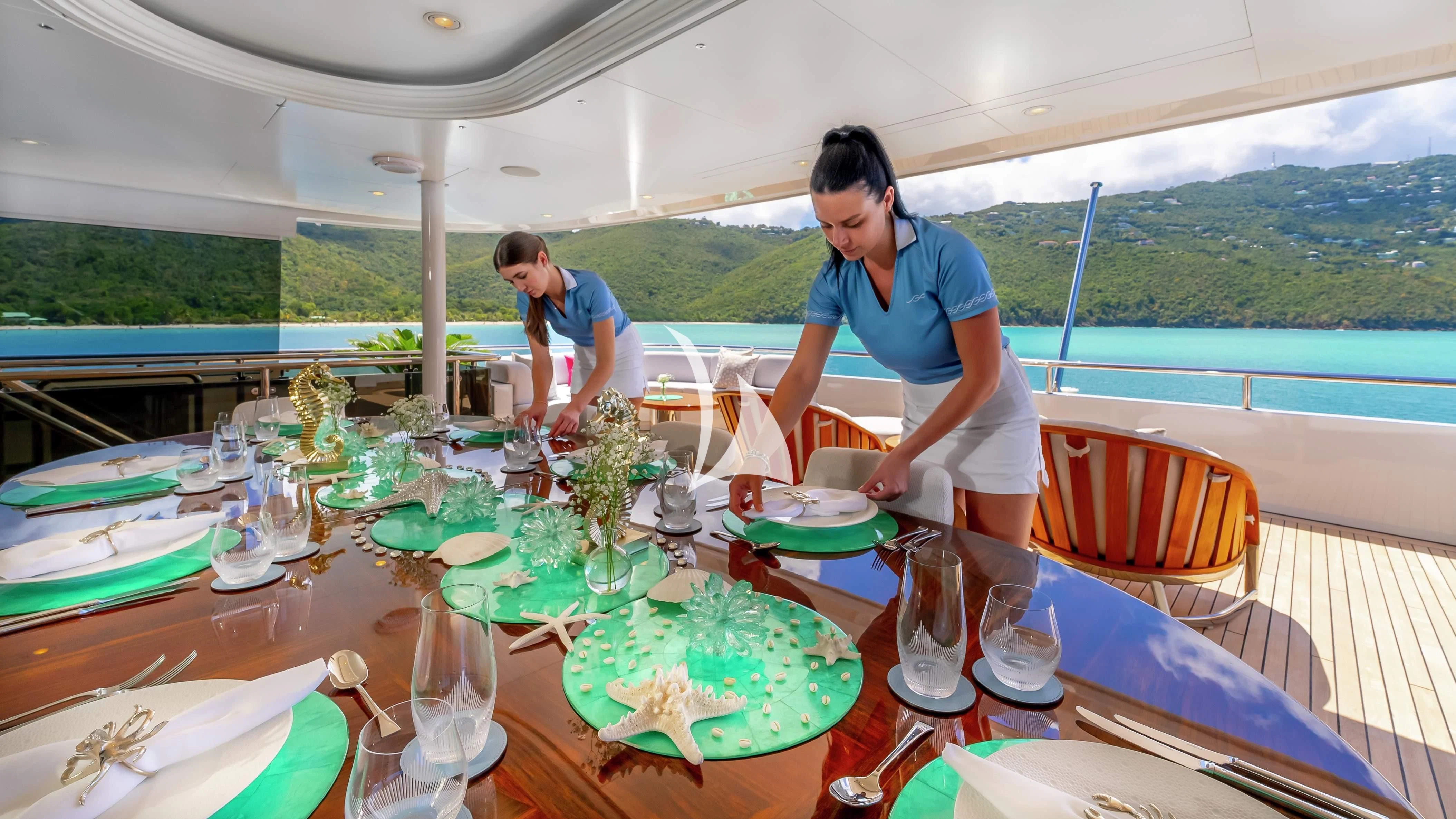 a couple of people sitting at a table with food on it aboard SCOTT FREE Yacht for Charter