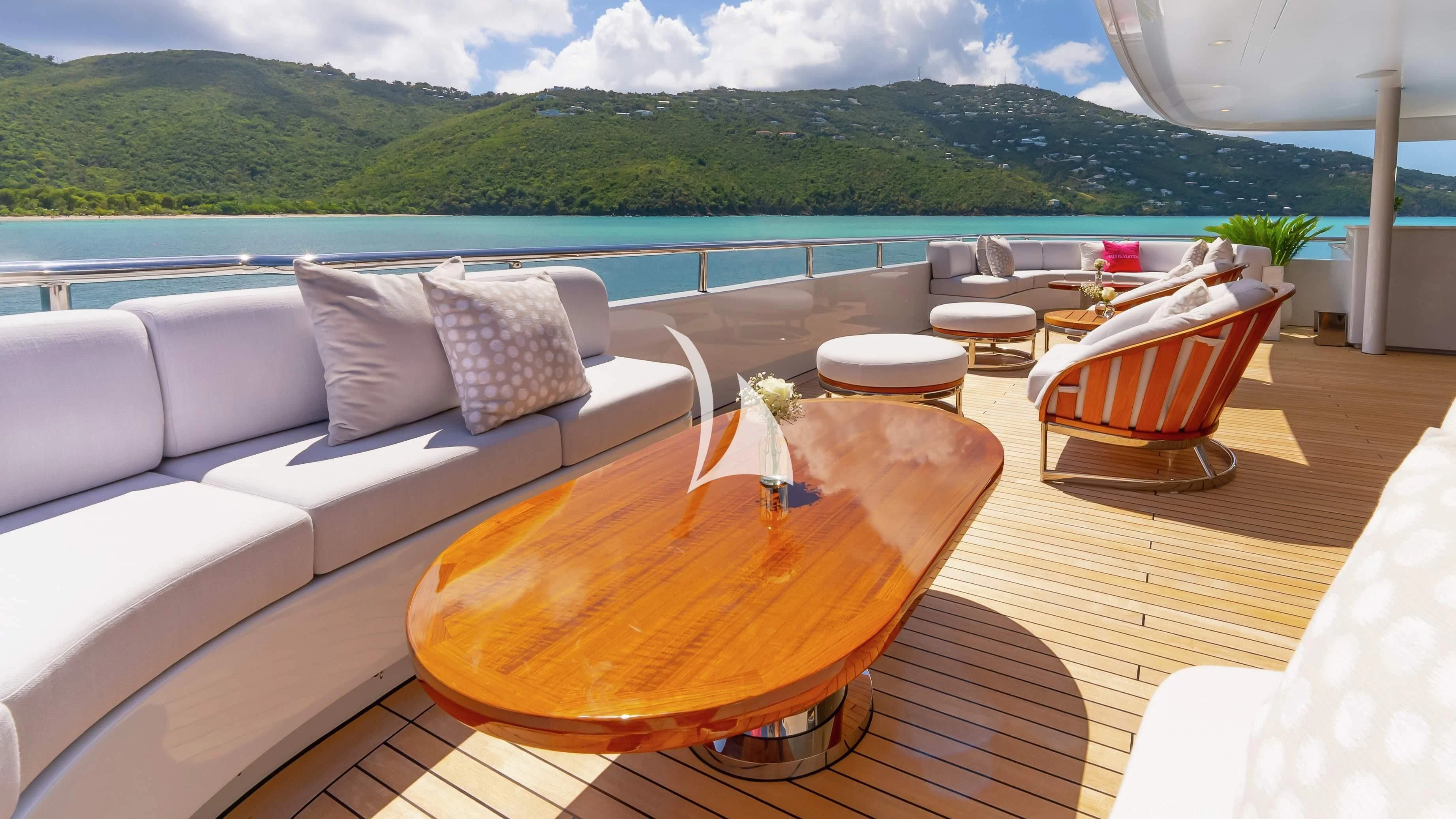 a table and chairs on a deck overlooking a body of water aboard SCOTT FREE Yacht for Charter