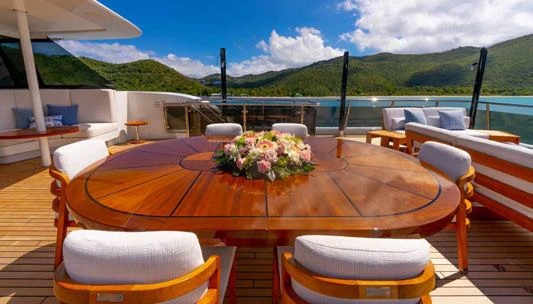 a table with flowers on it aboard SCOTT FREE Yacht for Charter