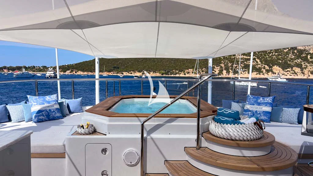 a large white tent with a table and chairs and a pool aboard SCOTT FREE Yacht for Charter