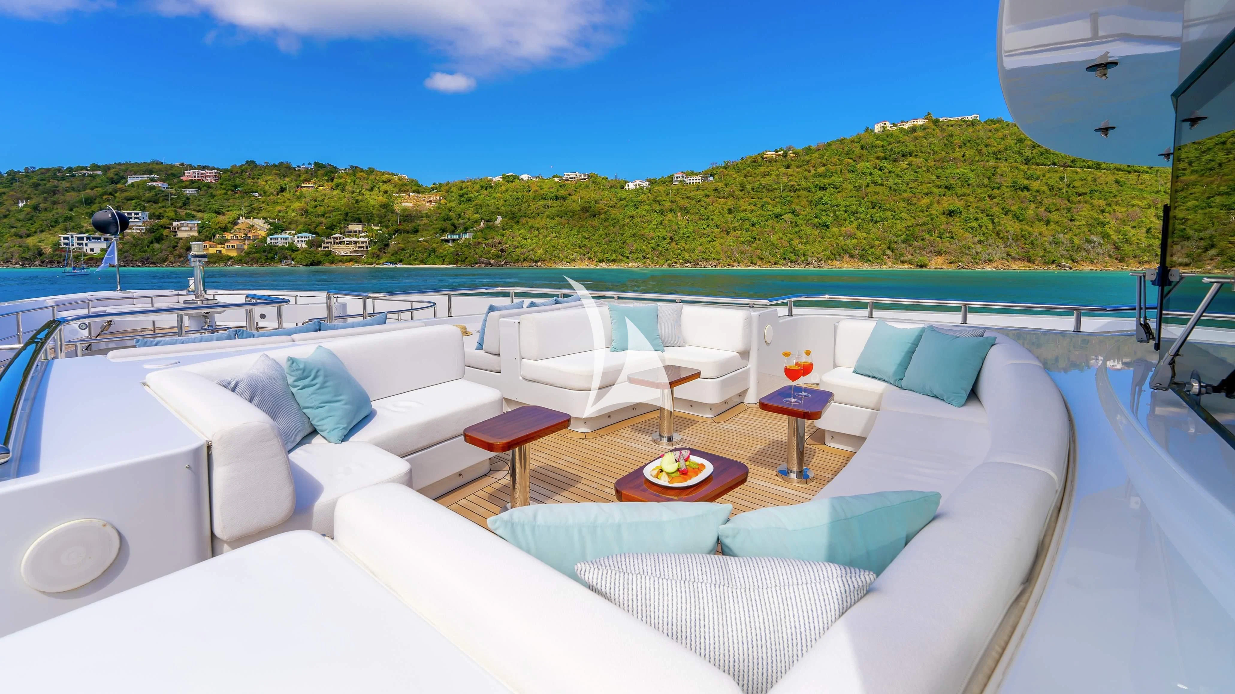 a large white lounge chair on a deck overlooking a large body of water aboard SCOTT FREE Yacht for Charter