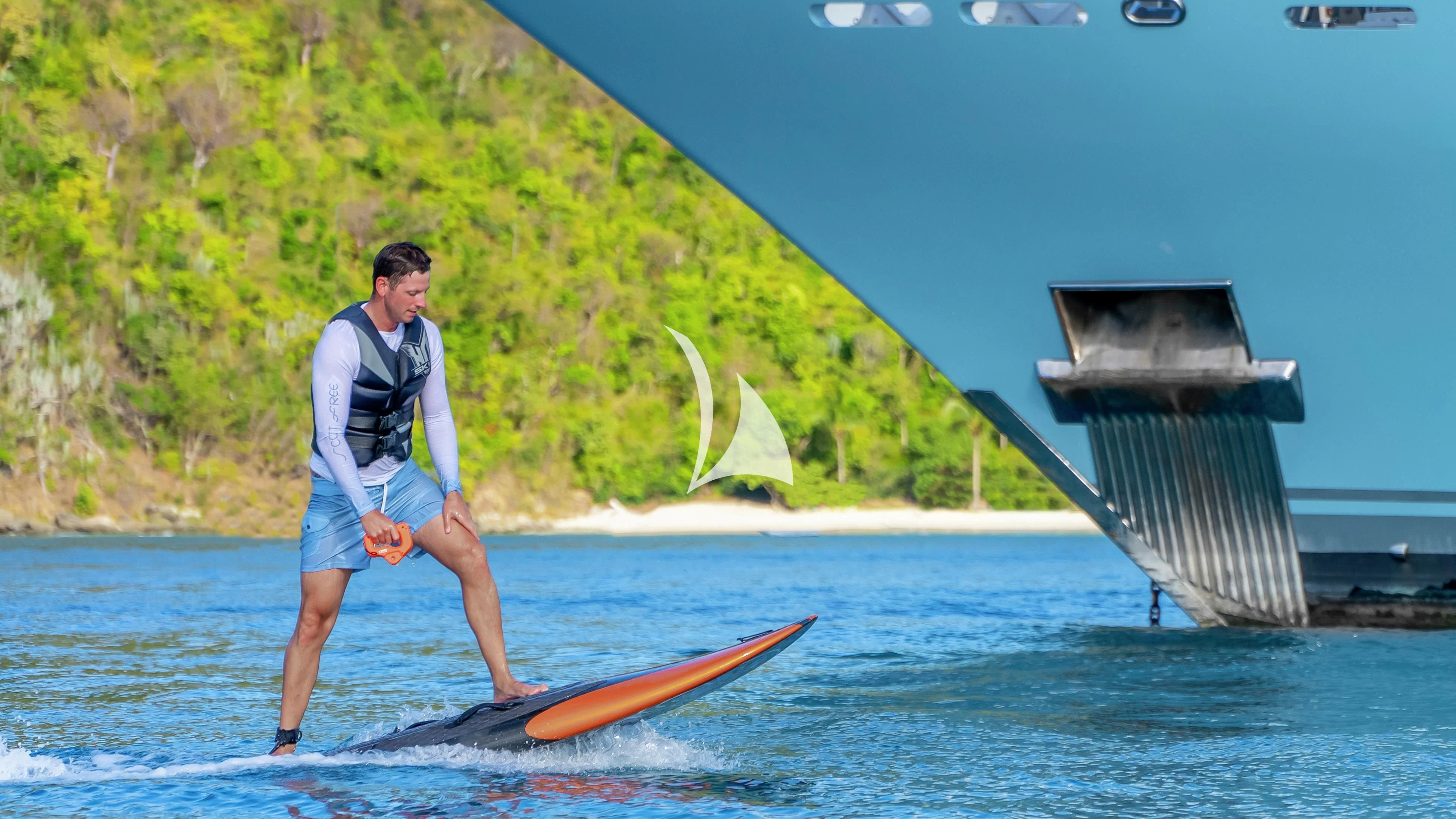 a person on a surfboard aboard SCOTT FREE Yacht for Charter