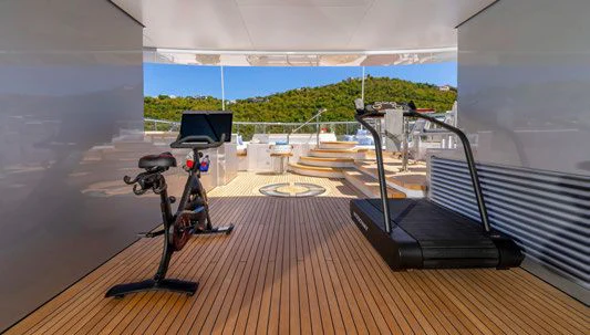 a room with a deck and a bicycle aboard SCOTT FREE Yacht for Charter
