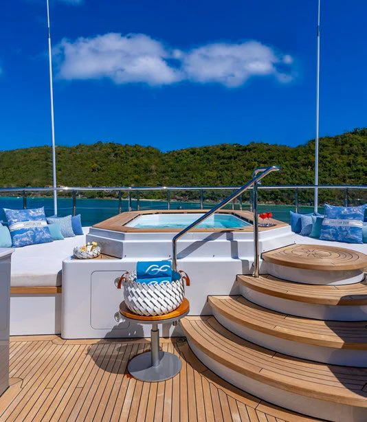 a deck with a table and chairs aboard SCOTT FREE Yacht for Charter