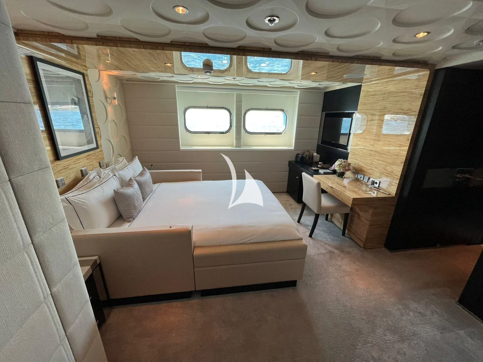 a room with a bed and a tv aboard SCOTT FREE Yacht for Charter