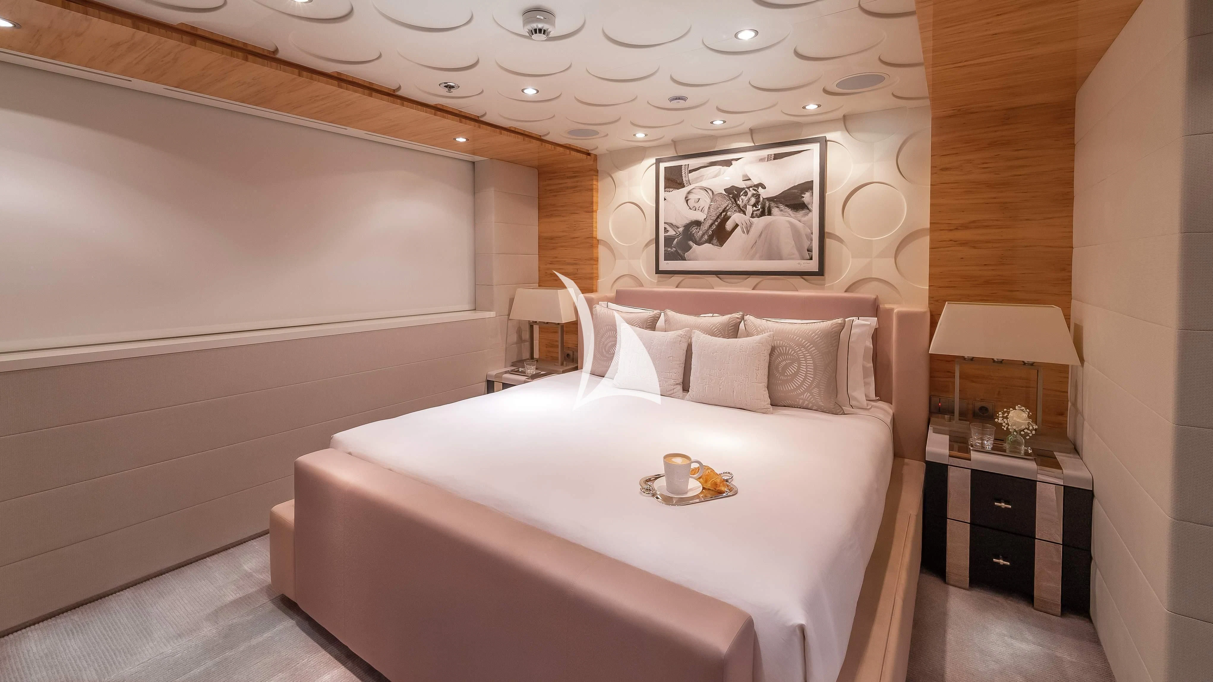 a bed with a white bed spread aboard SCOTT FREE Yacht for Charter