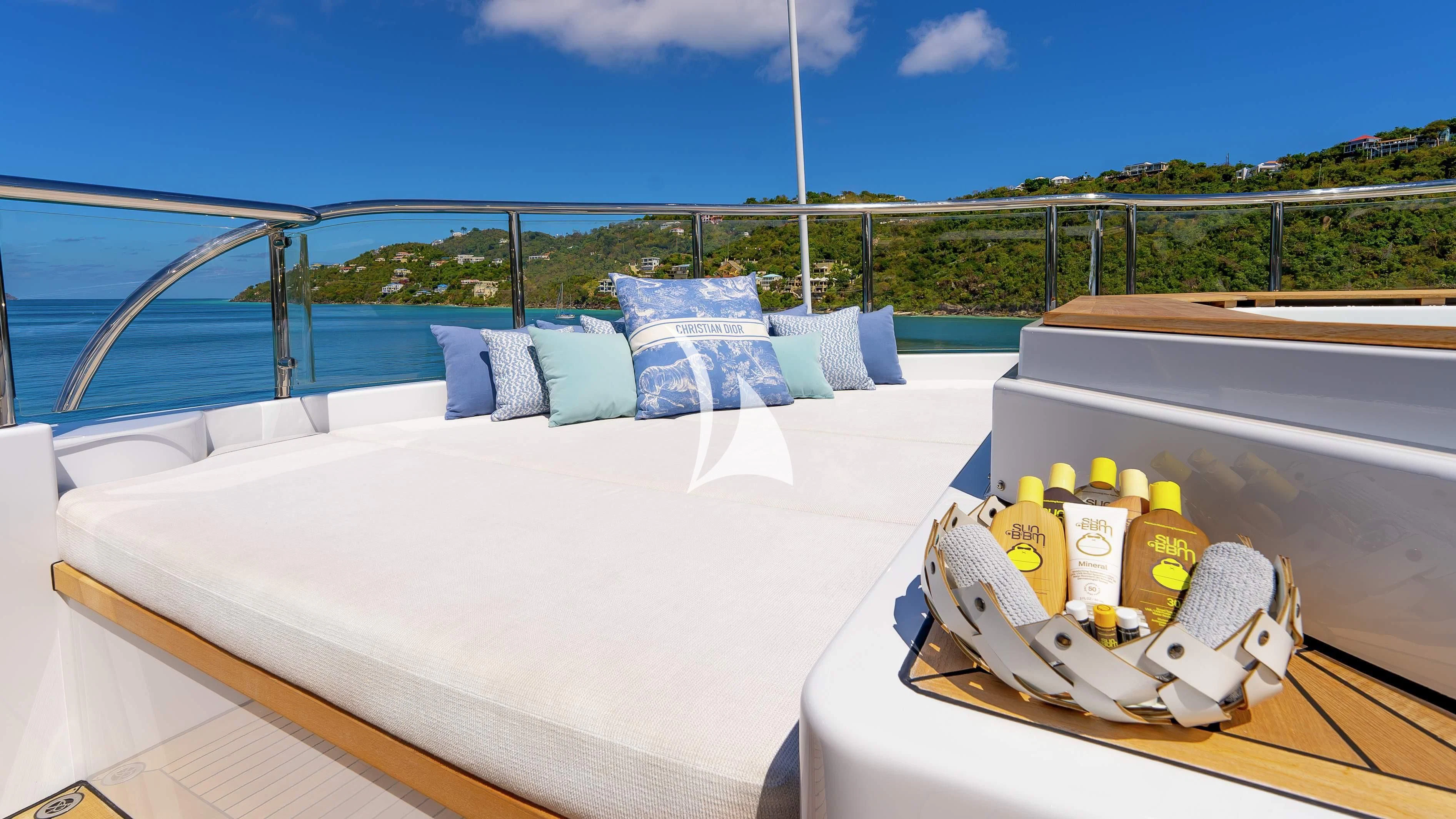 a white bed with blue pillows and a white blanket on it aboard SCOTT FREE Yacht for Charter