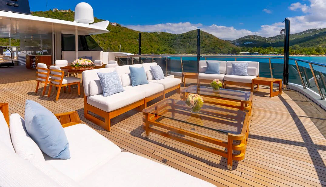 a deck with a table and chairs aboard SCOTT FREE Yacht for Charter