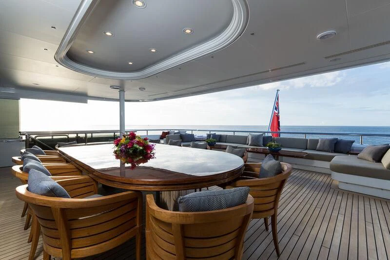 a large room with a table and chairs and a large window aboard SCOTT FREE Yacht for Charter