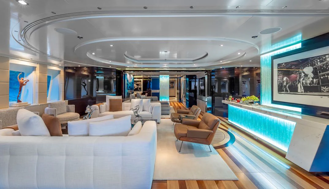 a large room with a large sofa and a large window aboard SCOTT FREE Yacht for Charter