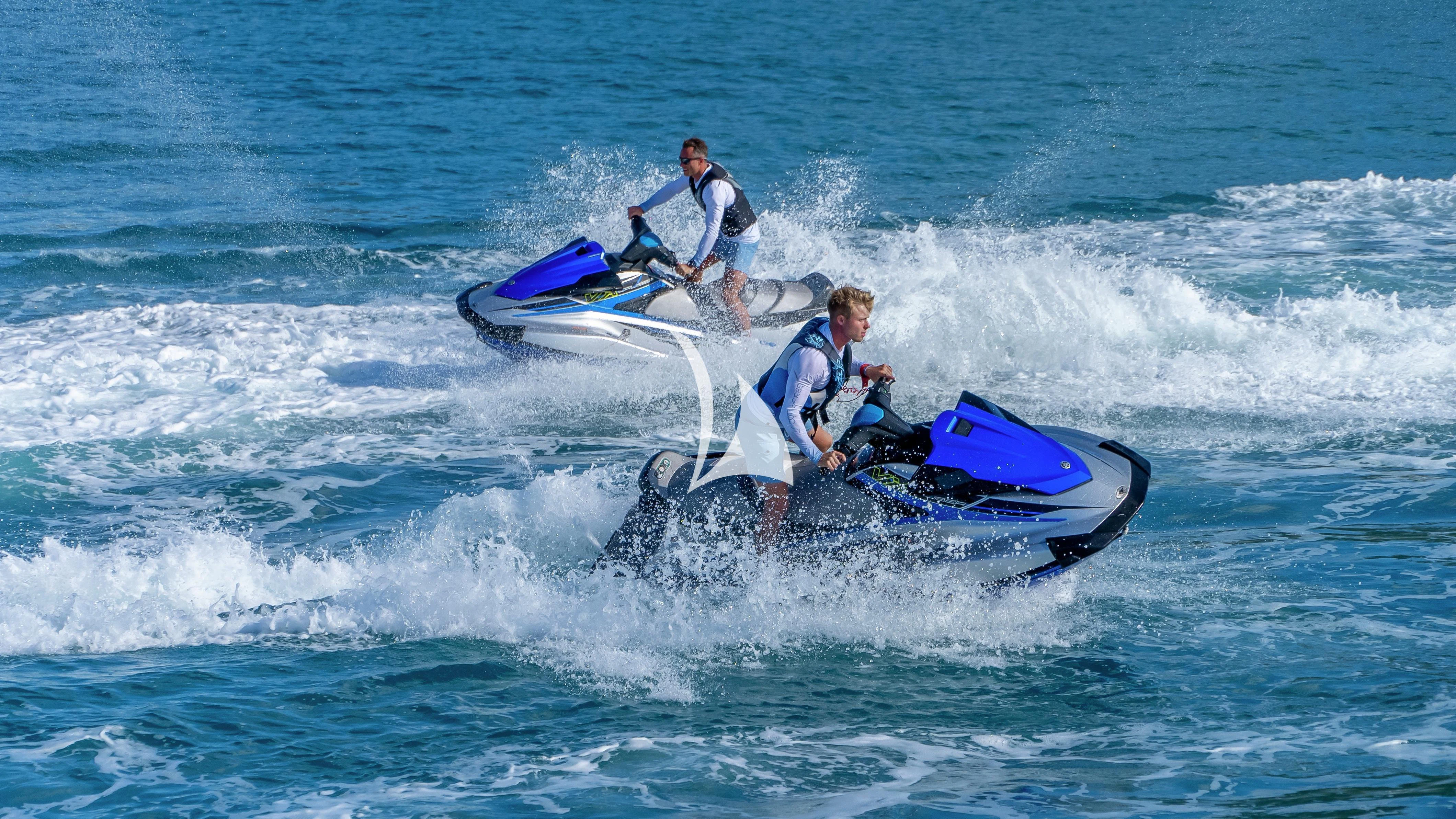a couple of men on a jet ski in the ocean aboard SCOTT FREE Yacht for Charter