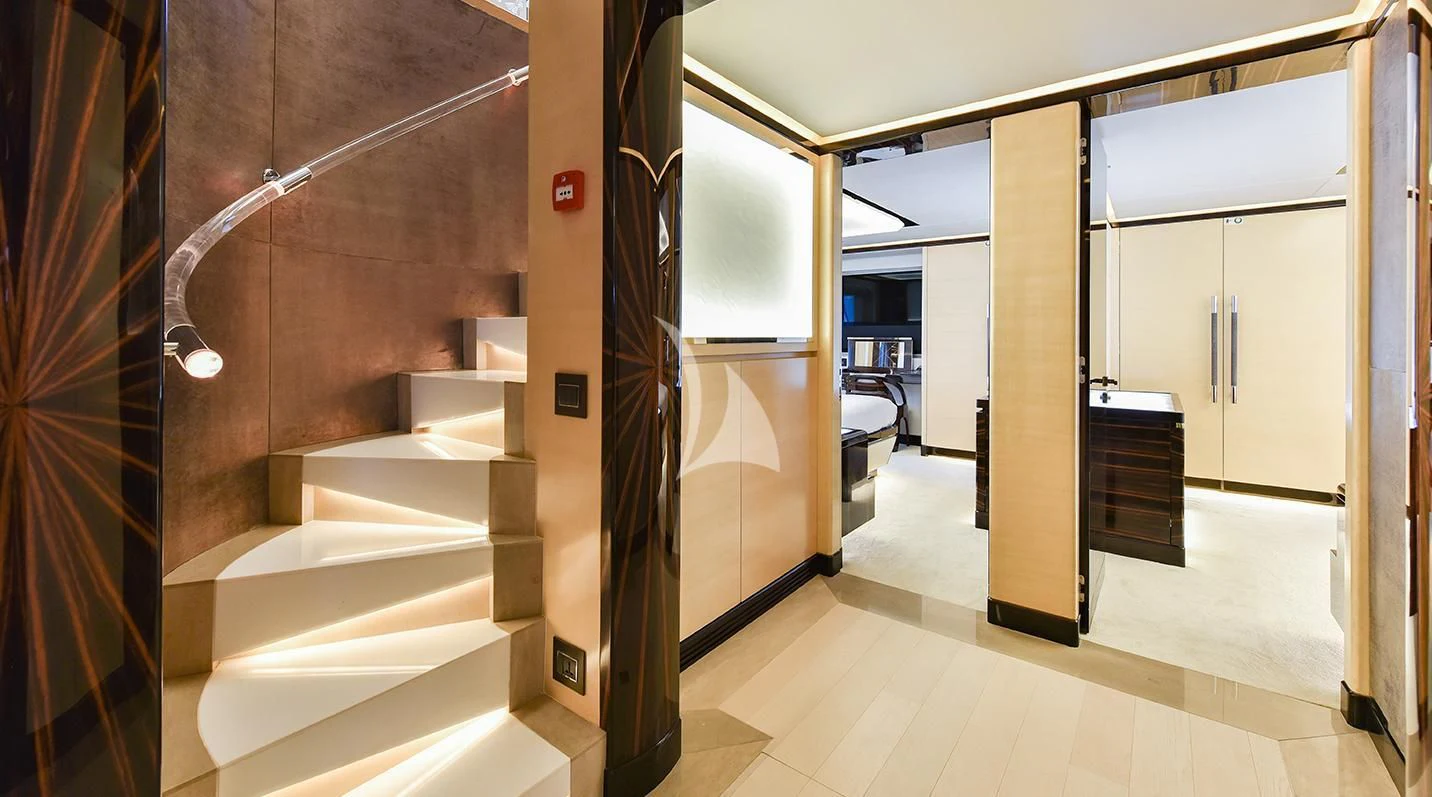 a hallway with a set of stairs aboard GHOST II Yacht for Sale