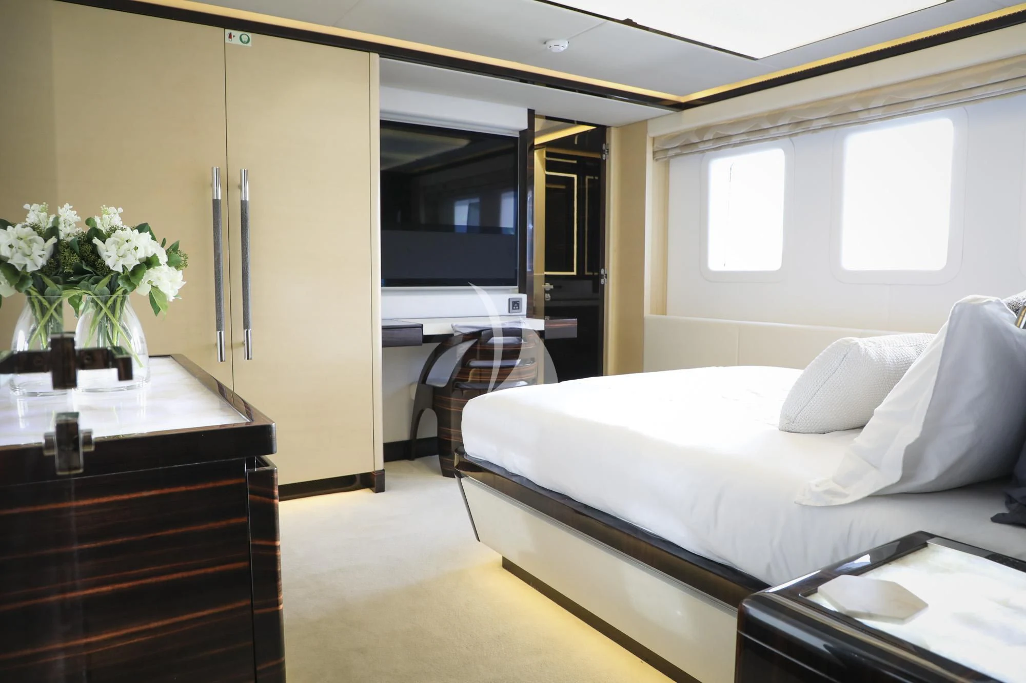 a room with a bed and a table aboard GHOST II Yacht for Sale