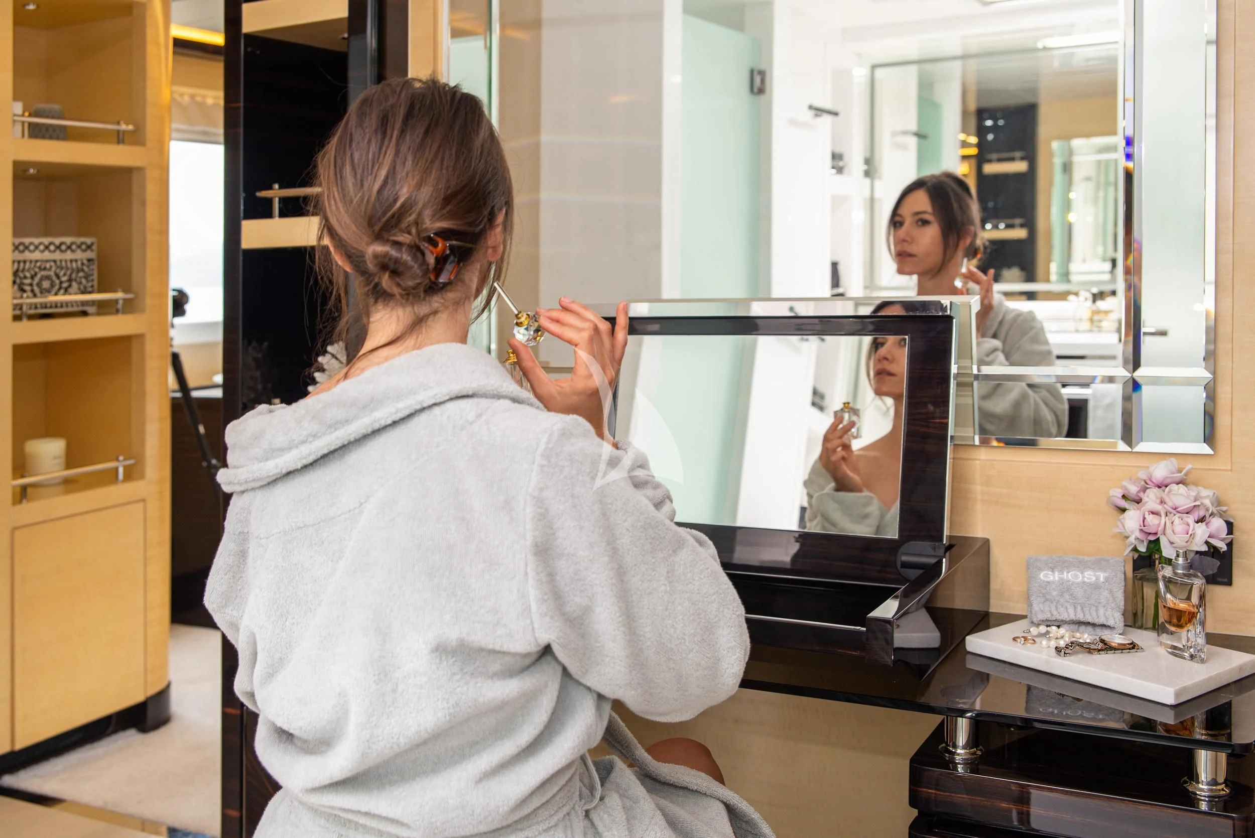 a person holding a device to the mouth aboard GHOST II Yacht for Sale