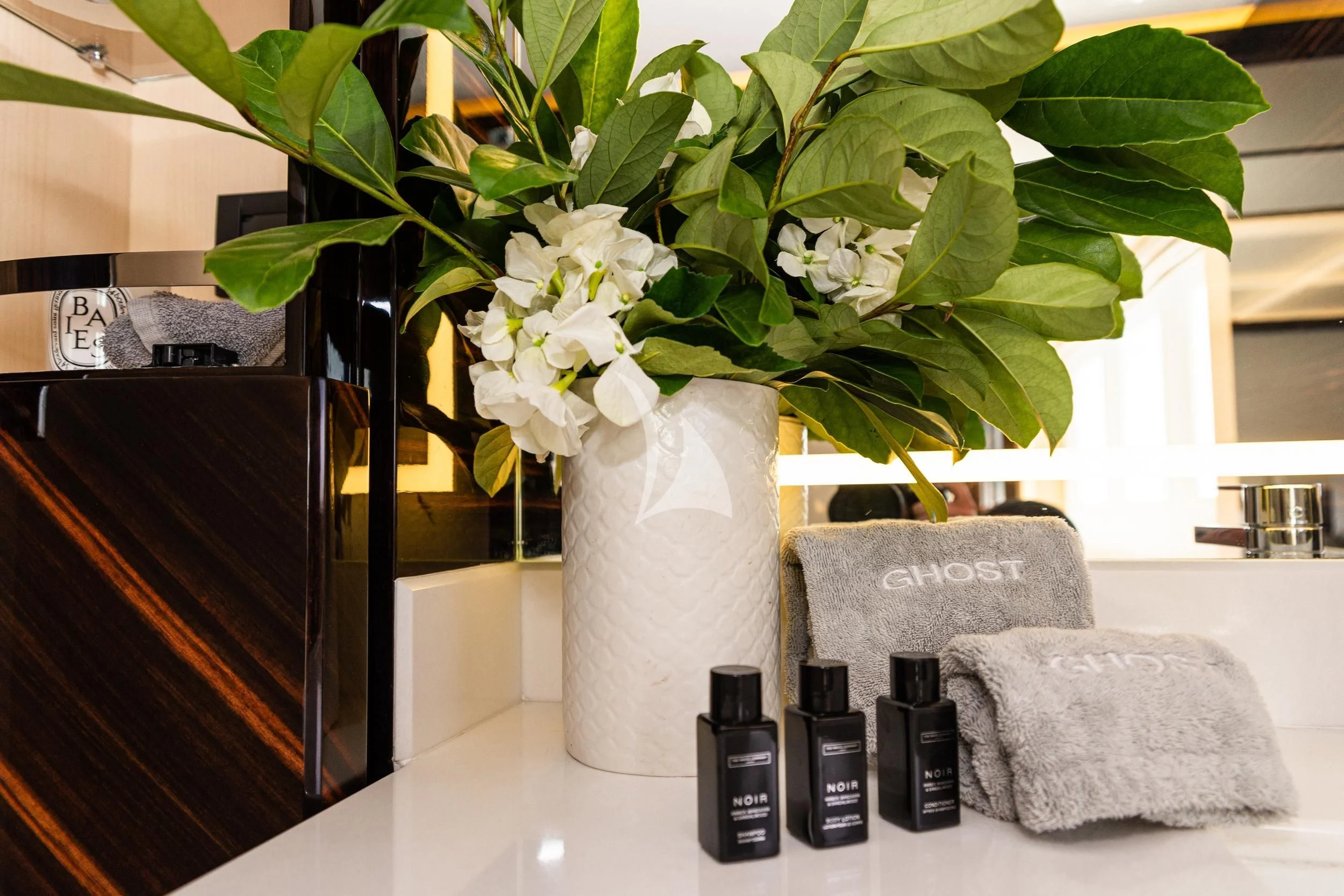 a vase with white flowers aboard GHOST II Yacht for Sale