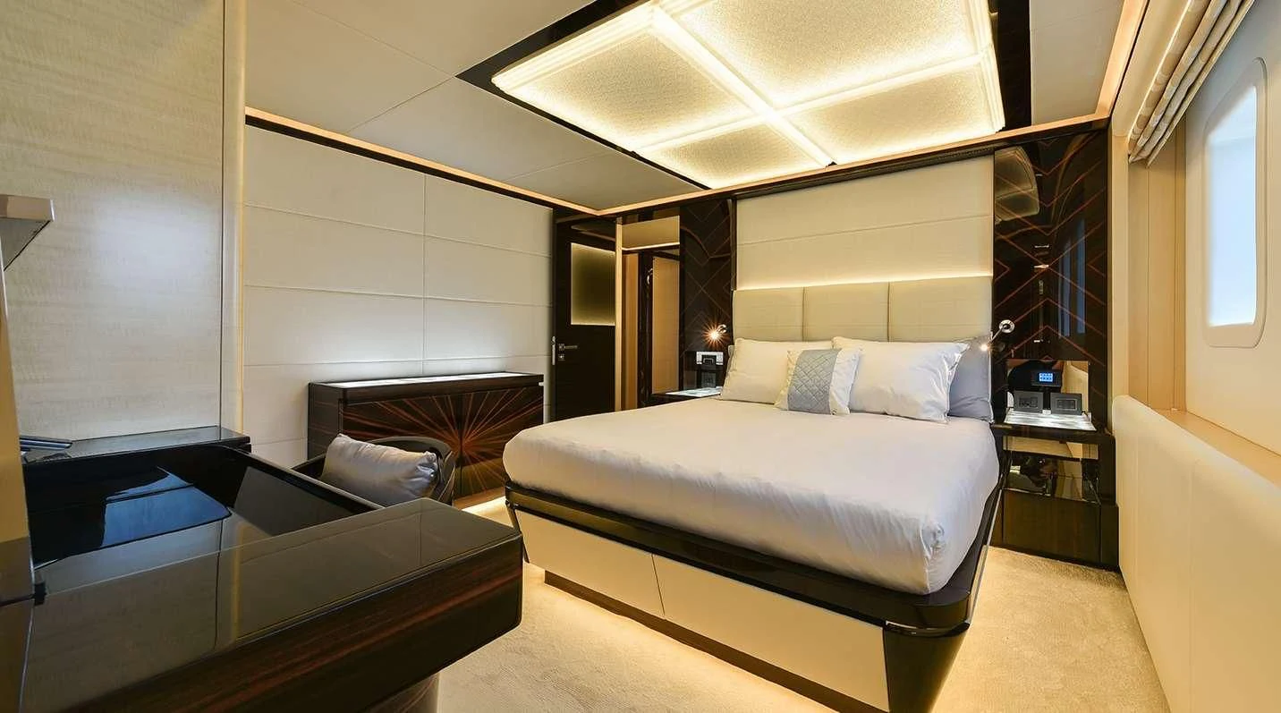 a room with a bed and a couch aboard GHOST II Yacht for Sale