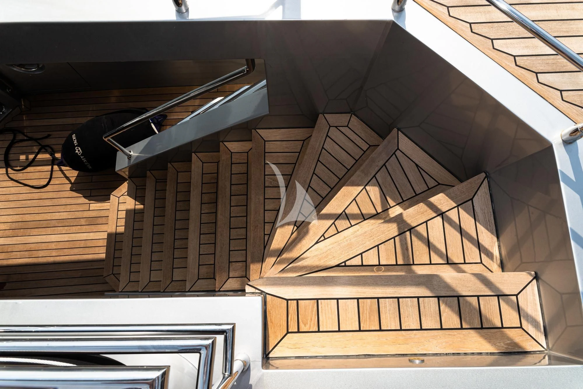 a wooden staircase with a glass window aboard GHOST II Yacht for Sale