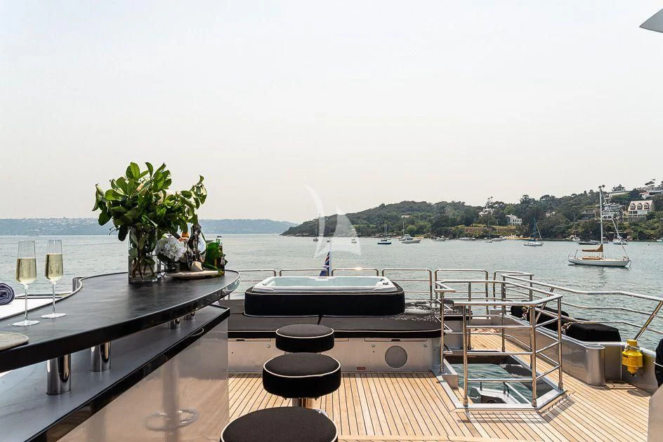 a table with plants on it by a body of water aboard GHOST II Yacht for Sale