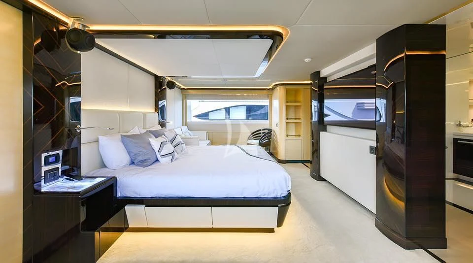 a room with a bed and a desk aboard GHOST II Yacht for Sale