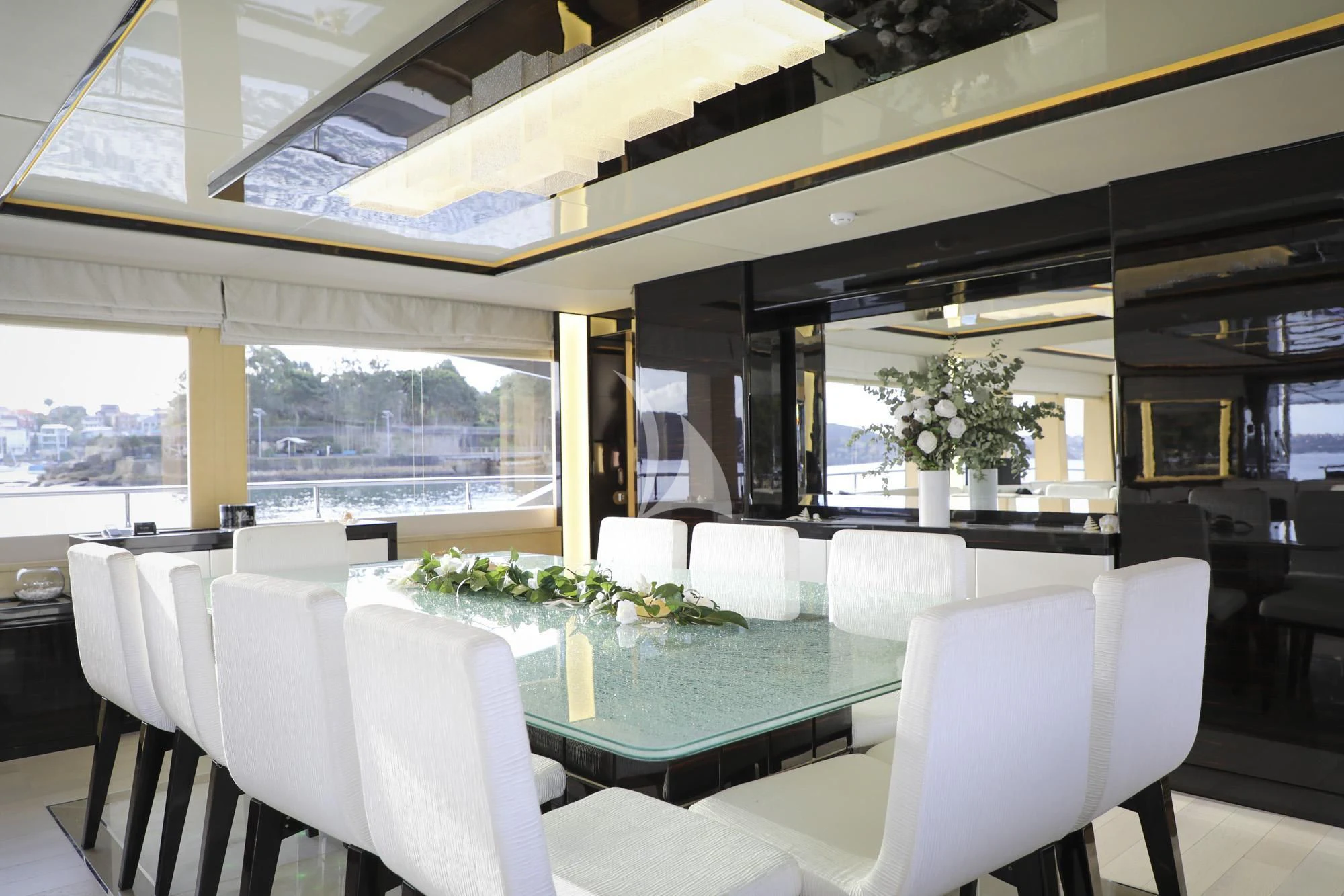 a room with tables and chairs aboard GHOST II Yacht for Sale
