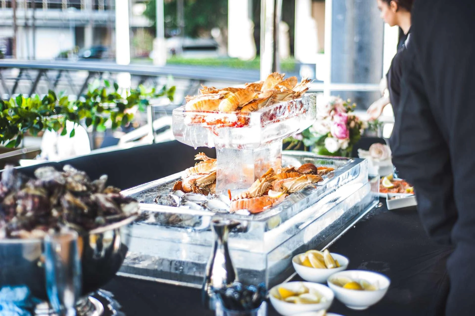 a group of people standing around a table full of food aboard GHOST II Yacht for Sale
