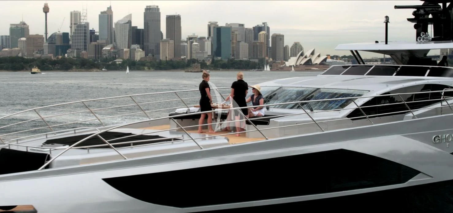a group of people standing on a boat in the water aboard GHOST II Yacht for Sale