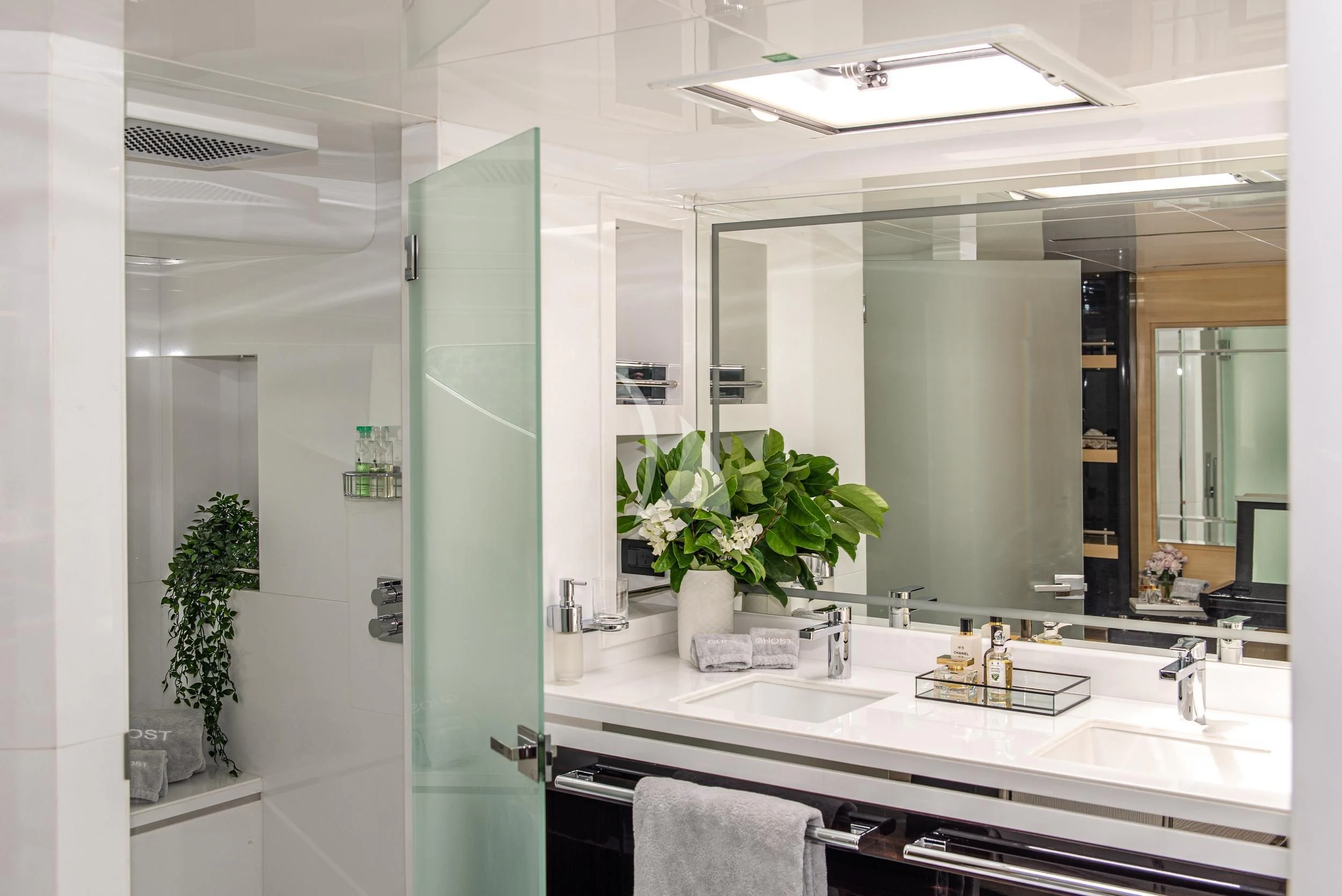 a bathroom with a large mirror aboard GHOST II Yacht for Sale