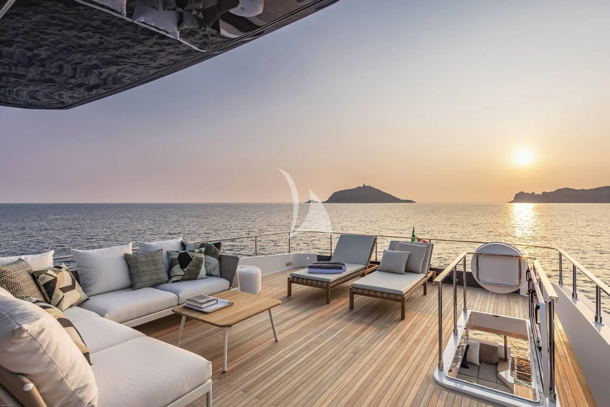 a deck with a couch and a table on it aboard PIOLA Yacht for Sale