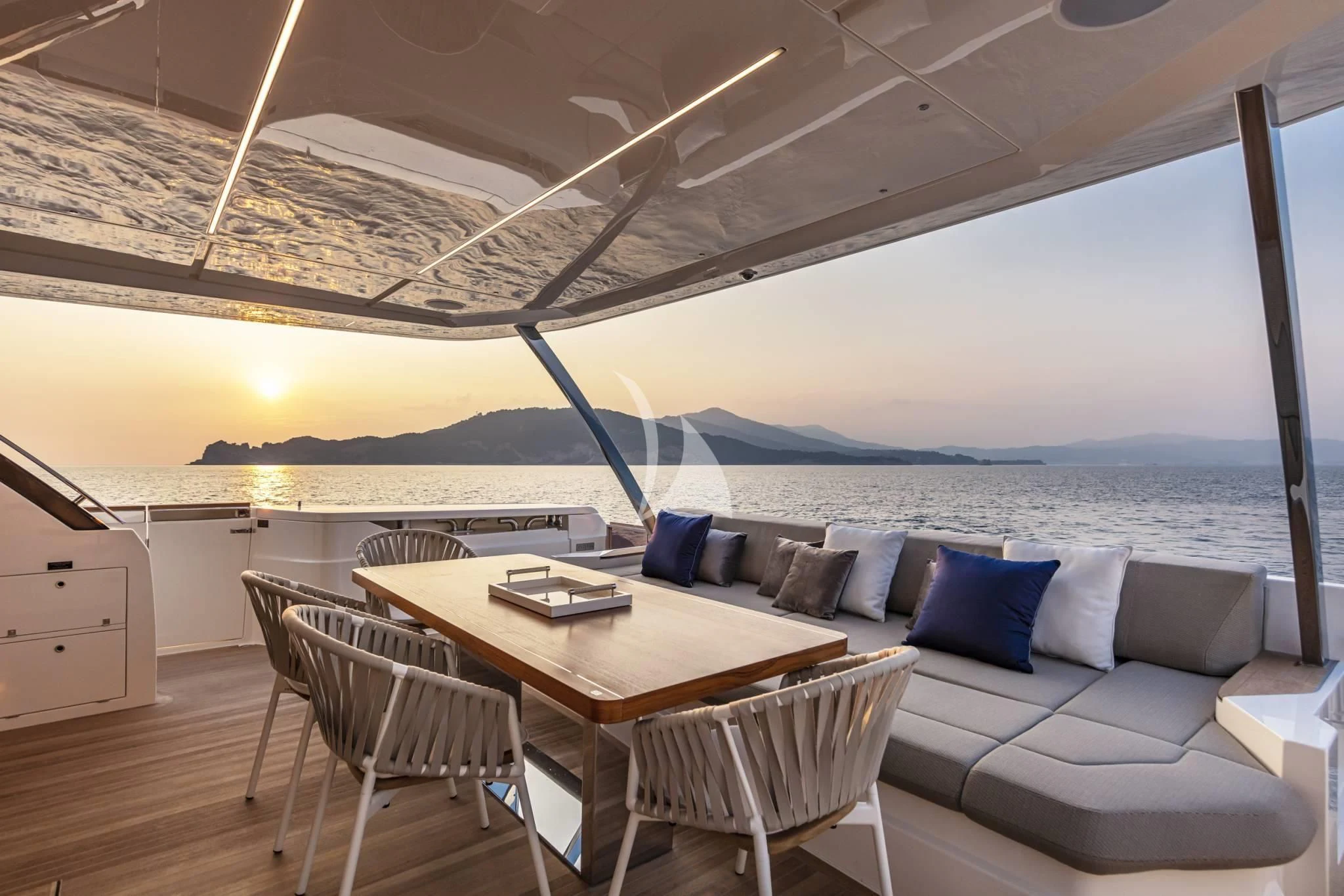 a room with a couch and a table and a large window aboard PIOLA Yacht for Sale