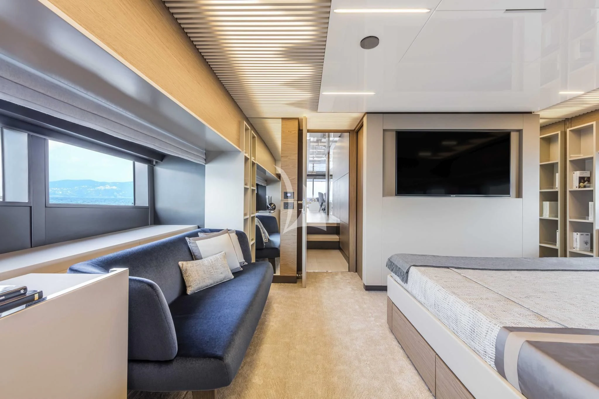 a room with a bed and a couch aboard PIOLA Yacht for Sale