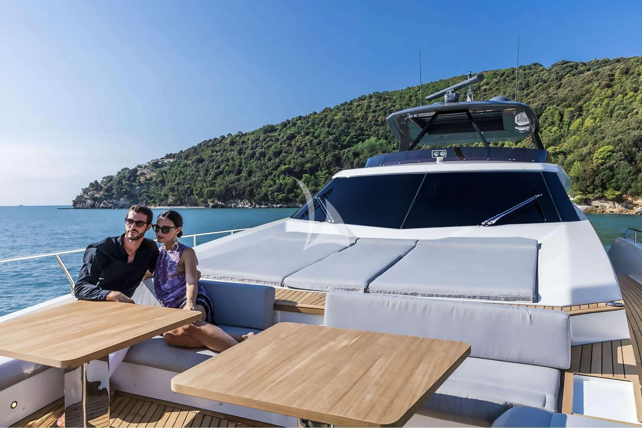 a couple of people sitting on a boat in the water aboard PIOLA Yacht for Sale