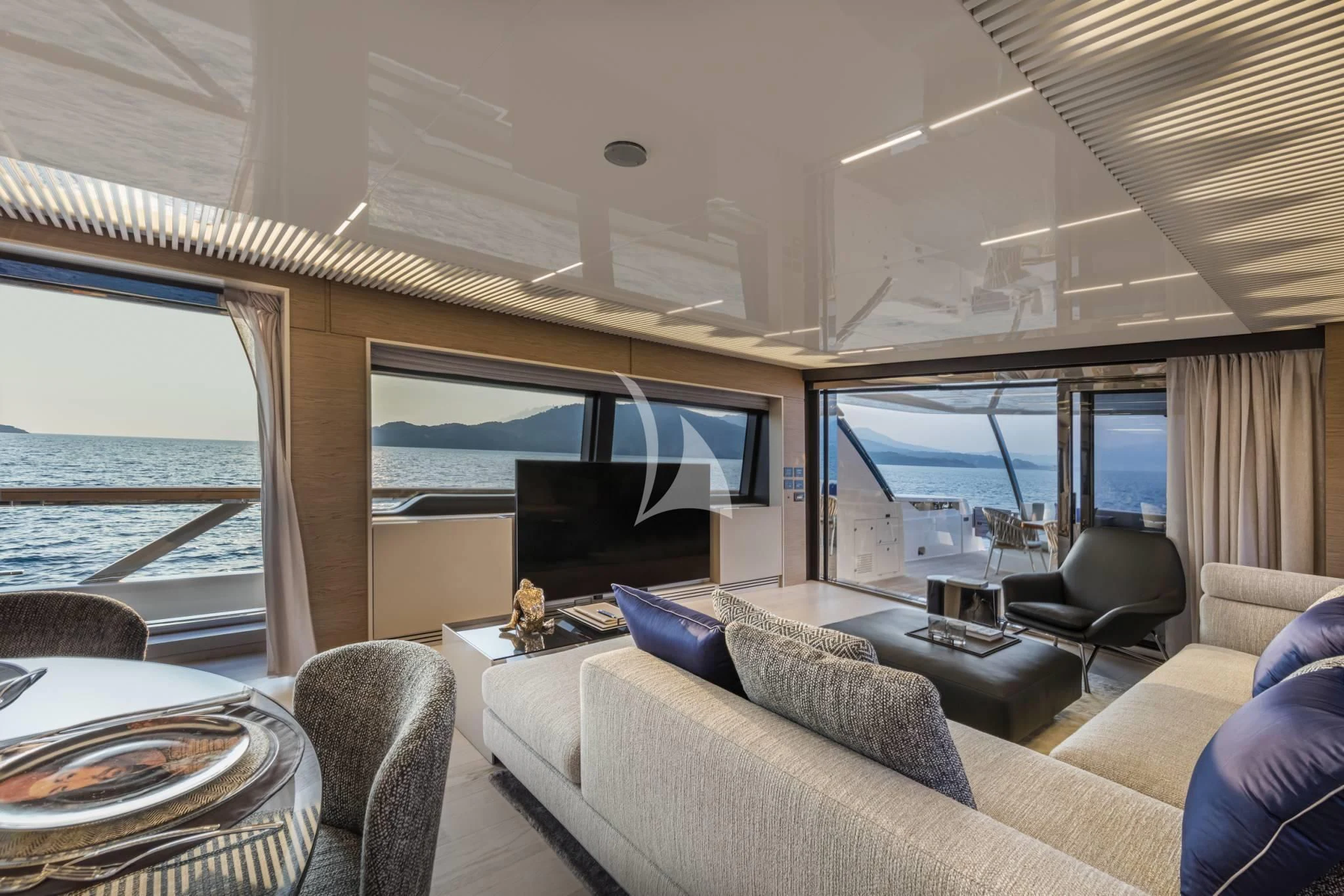 a room with a couch and a television aboard PIOLA Yacht for Sale