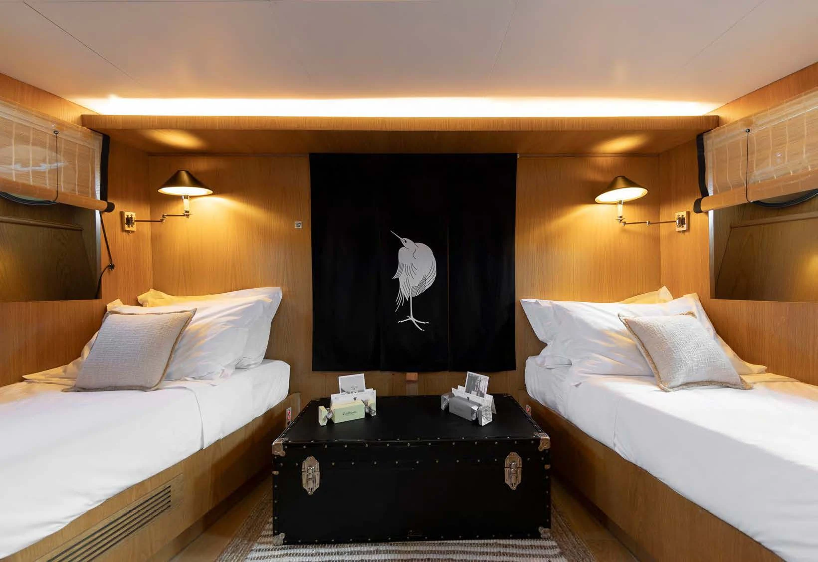 a room with a bed and a black dresser aboard SOUNION II Yacht for Sale