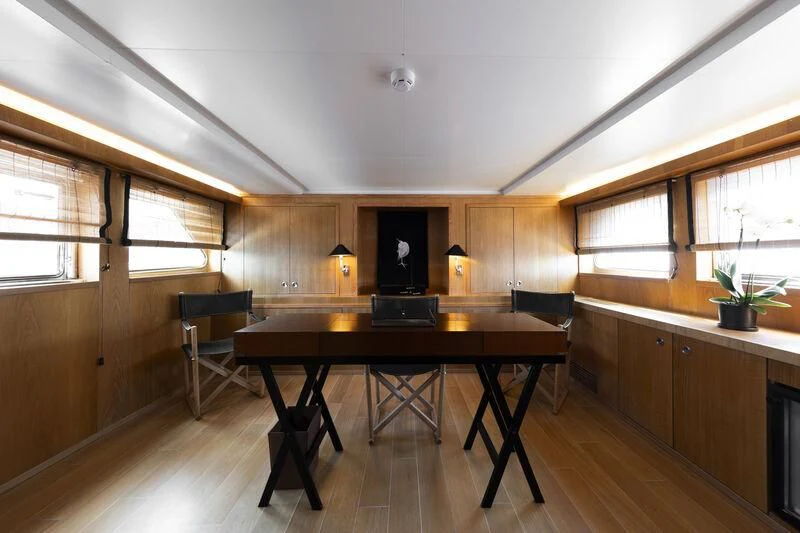 a kitchen with a table and chairs aboard SOUNION II Yacht for Sale