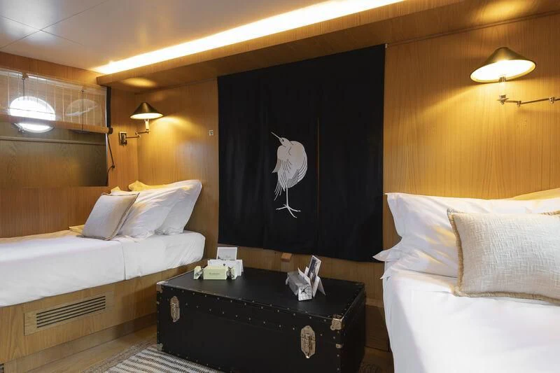 a room with a bed and a black curtain aboard SOUNION II Yacht for Sale