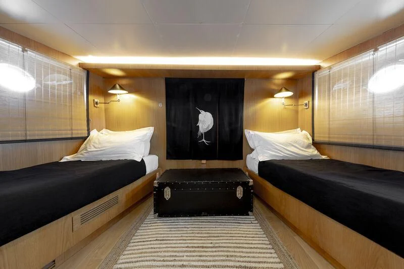 a room with a bed and a painting on the wall aboard SOUNION II Yacht for Sale