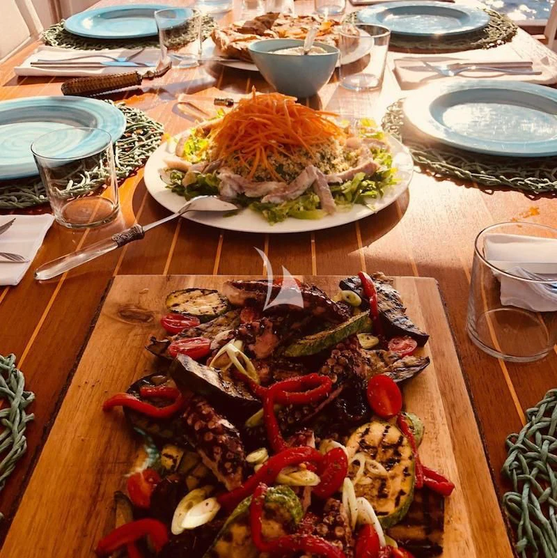 a table with plates of food and glasses on it aboard SOUNION II Yacht for Sale