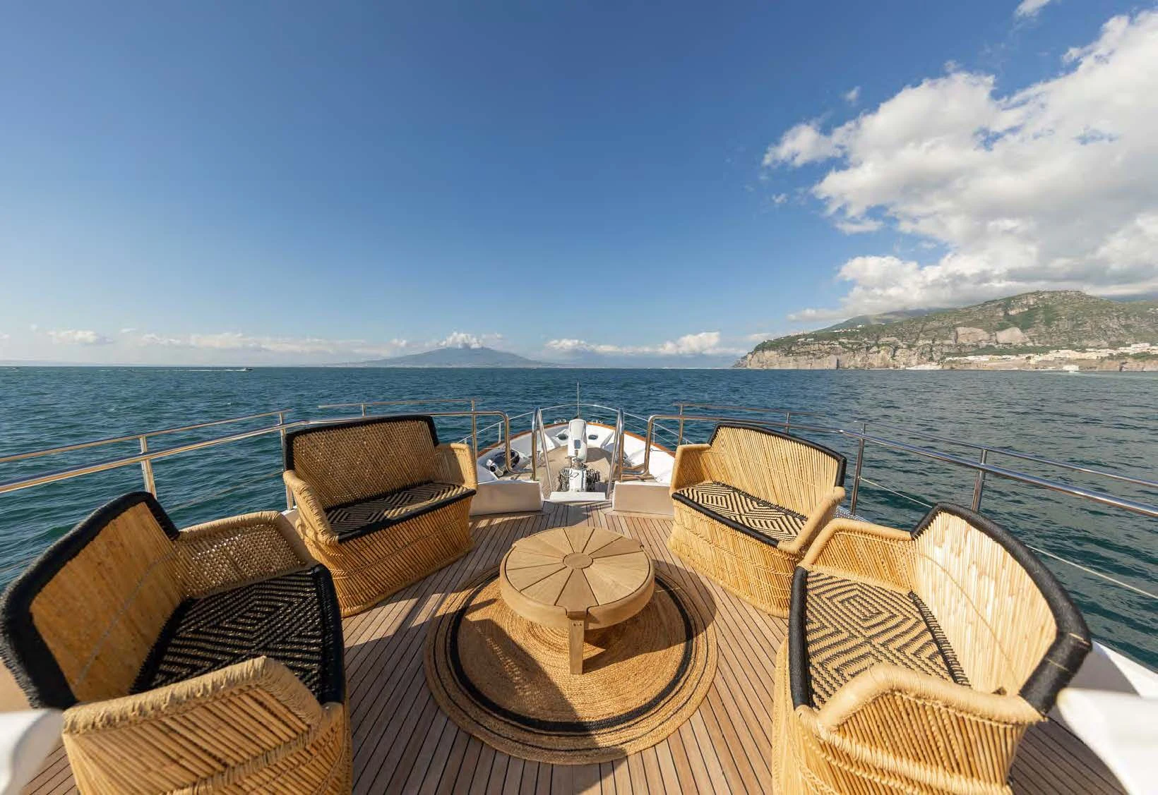 a table with chairs on it by the water aboard SOUNION II Yacht for Sale
