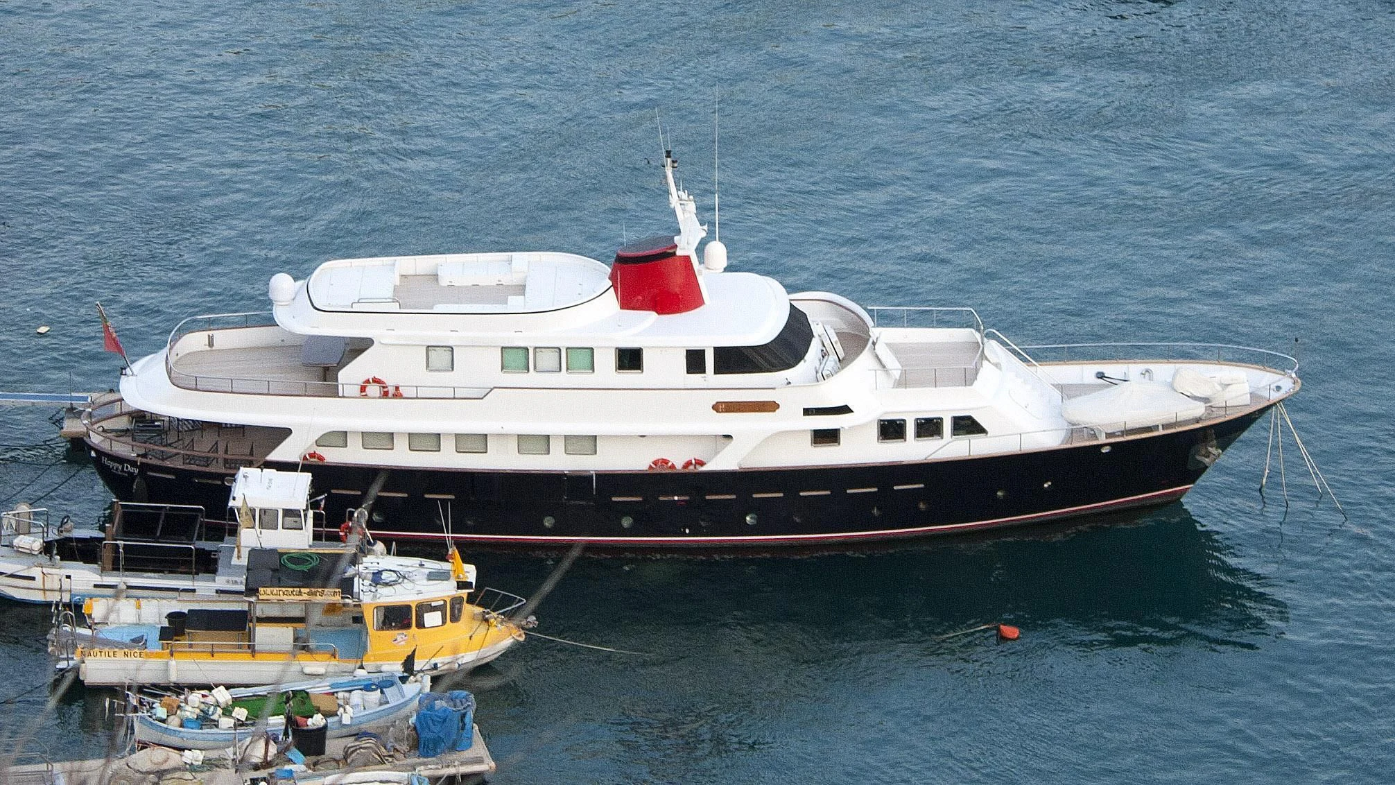 a large white boat with a yellow boat on the water aboard SOUNION II Yacht for Sale