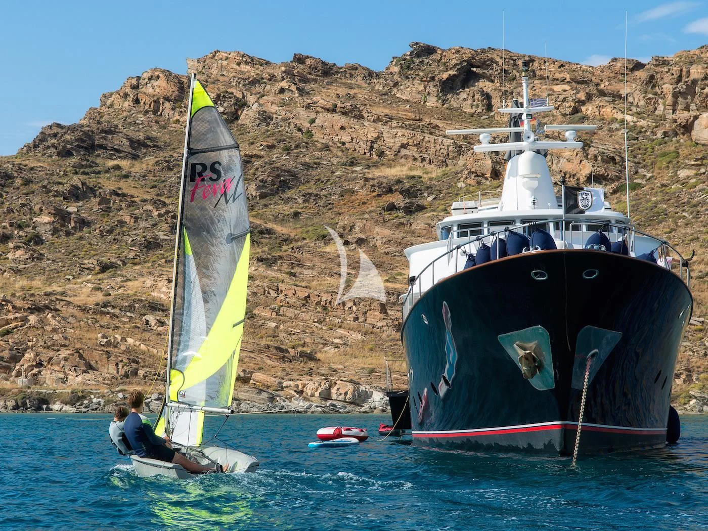 a couple of people on a sailboat in the water aboard SOUNION II Yacht for Sale