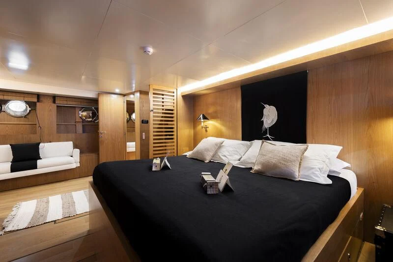 a room with a bed and a couch aboard SOUNION II Yacht for Sale