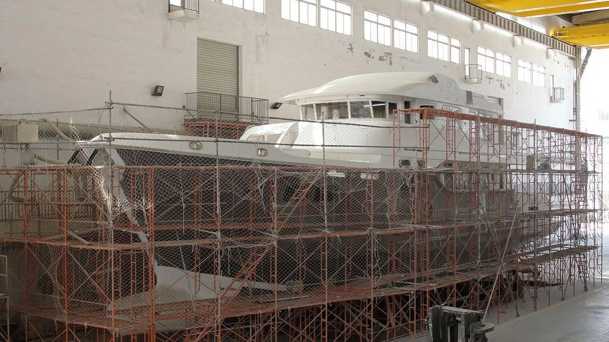 a large white boat in a warehouse aboard MACGUFFIN Yacht for Sale