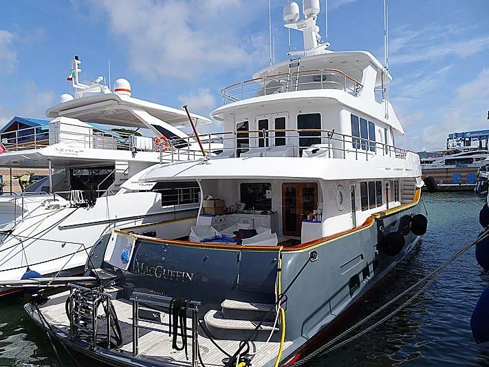 a large white boat in a harbor aboard MACGUFFIN Yacht for Sale