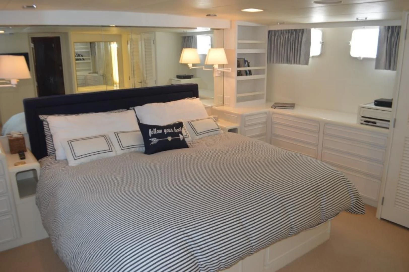 a large bed in a hotel room aboard ENCORE V Yacht for Sale