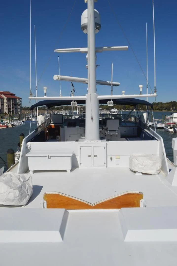 a white boat with a satellite dish on it aboard ENCORE V Yacht for Sale