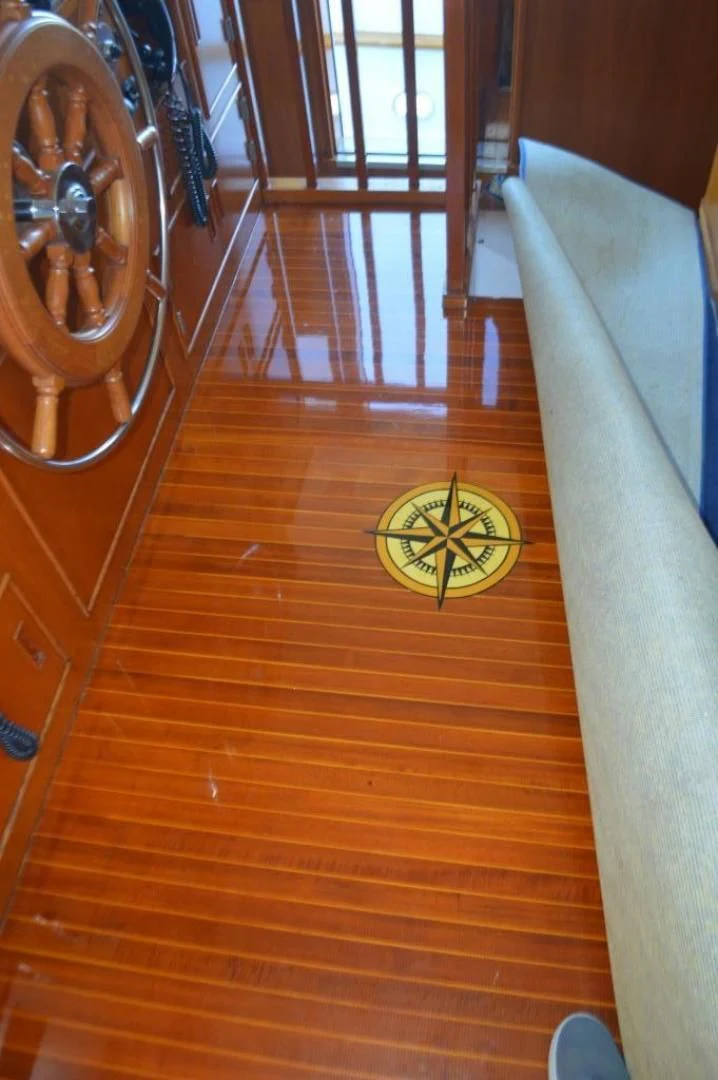 a wooden staircase with a round clock aboard ENCORE V Yacht for Sale